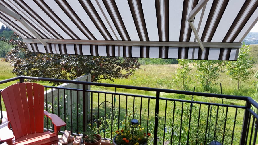 patio-with-awning-overlooking-backyard-with-garden-and-trees Patio with awning overlooking backyard with garden and trees